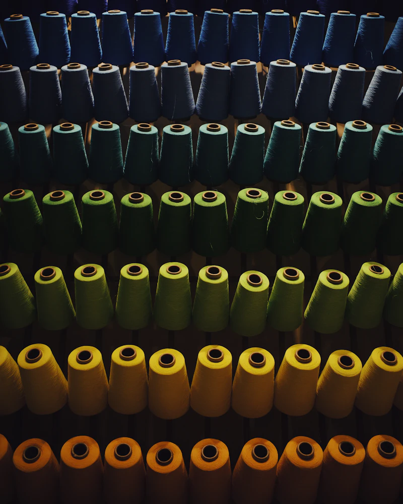 Spools of thread in assorted colours on a production rack