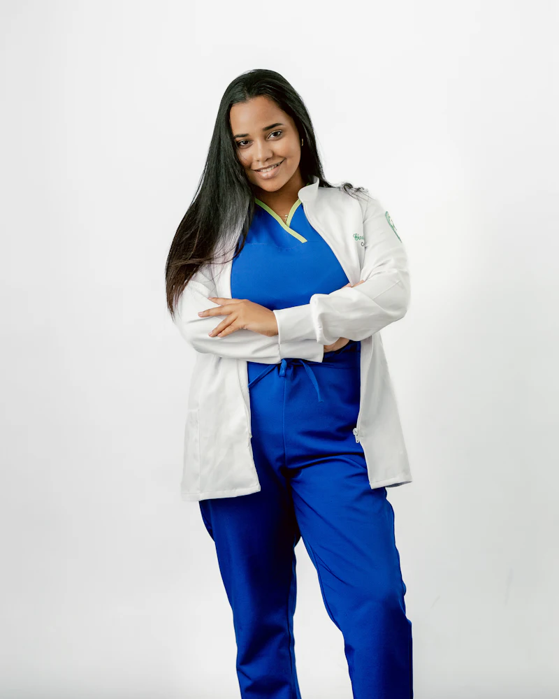 Healthcare professional wearing scrubs and a white lab coat